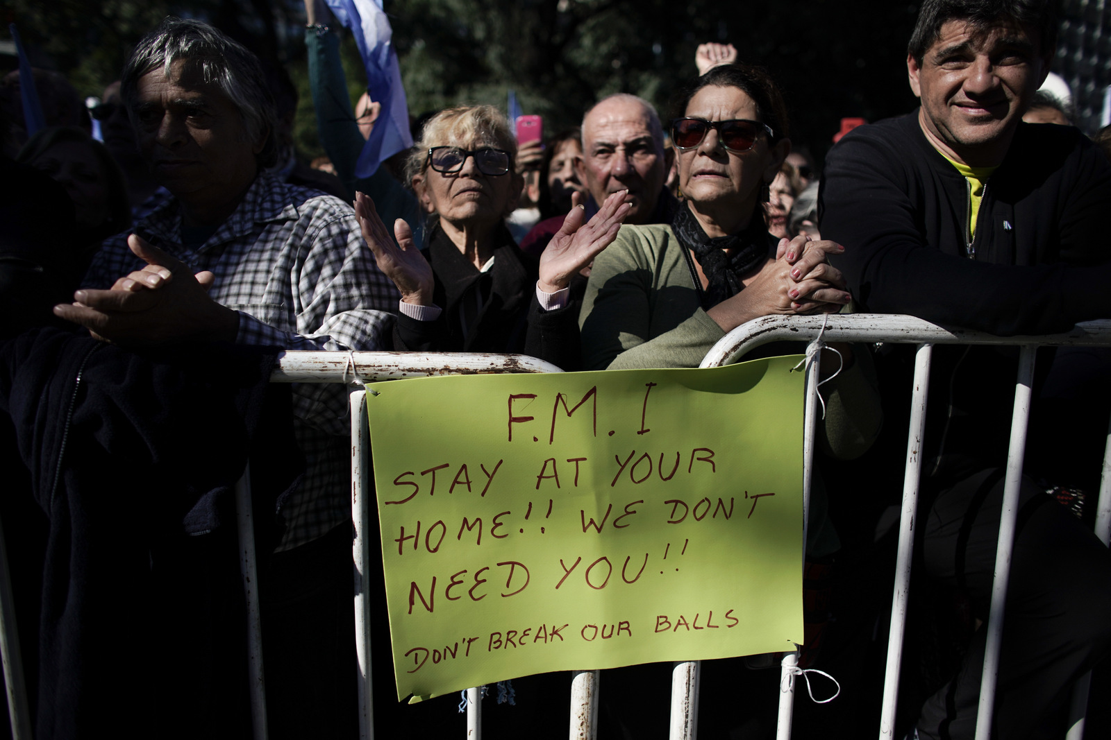 Protesters stand behind a barrier with a sign bearing a message for the FMI, the Spanish acronym for International Monetary Fund, during a protest in Buenos Aires, Argentina, May 25, 2018. Victor R. Caivano | AP