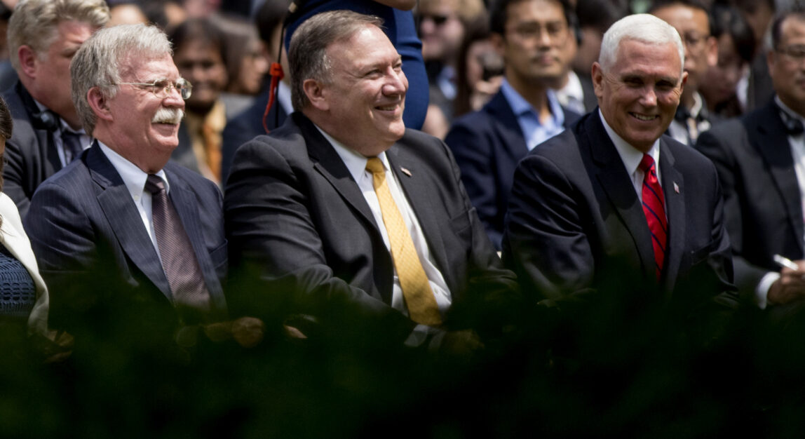 From left, national security adviser John Bolton, Secretary of State Mike Pompeo, and Vice President Mike Pence, share a laugh together before a news conference at the White House, June 7, 2018. Andrew Harnik | AP