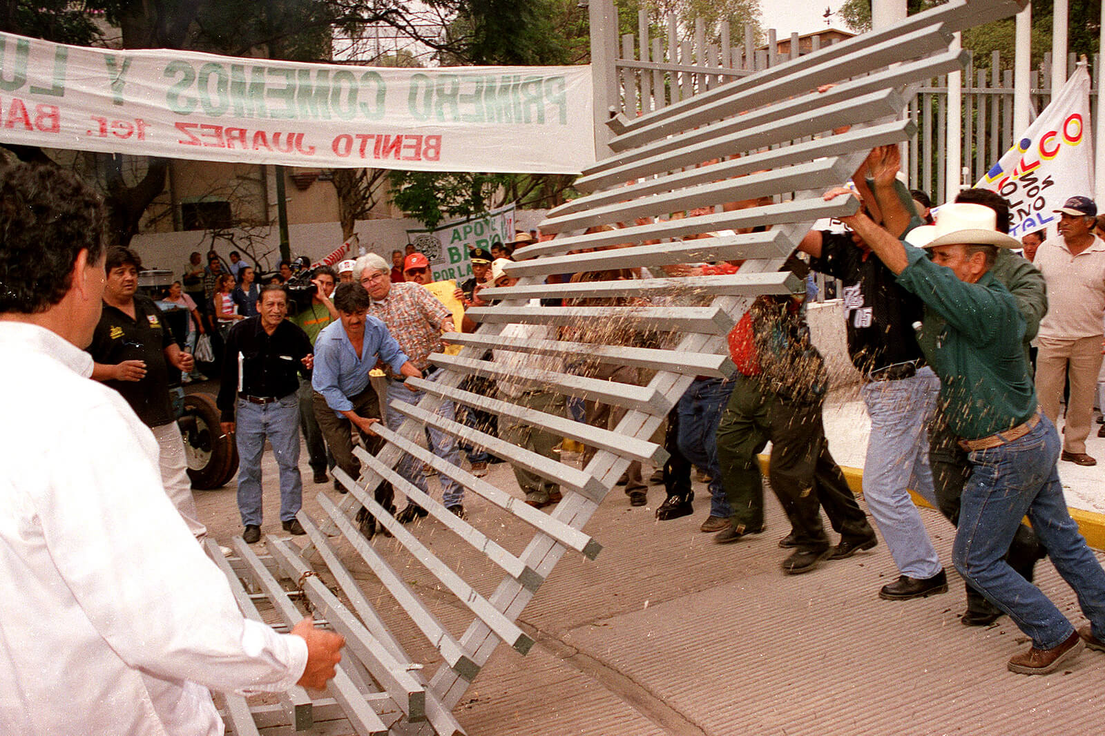 Farmers break the gate of the Economy Ministry during a protest against NAFTA agreement which they say affect the price of their products, Oct. 29, 2002, in Mexico City.Ismael Rojas | AP