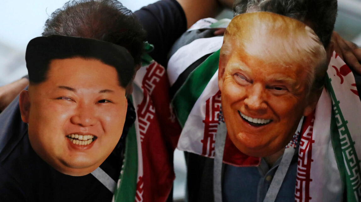 Iran fans wear masks representing U.S. President Donald Trump, right, and North Korean leader Kim Jong Un as they await the start of a group B match between Iran and Spain at the 2018 soccer World Cup in the Kazan Arena in Kazan, Russia, June 20, 2018. Eugene Hoshiko | AP