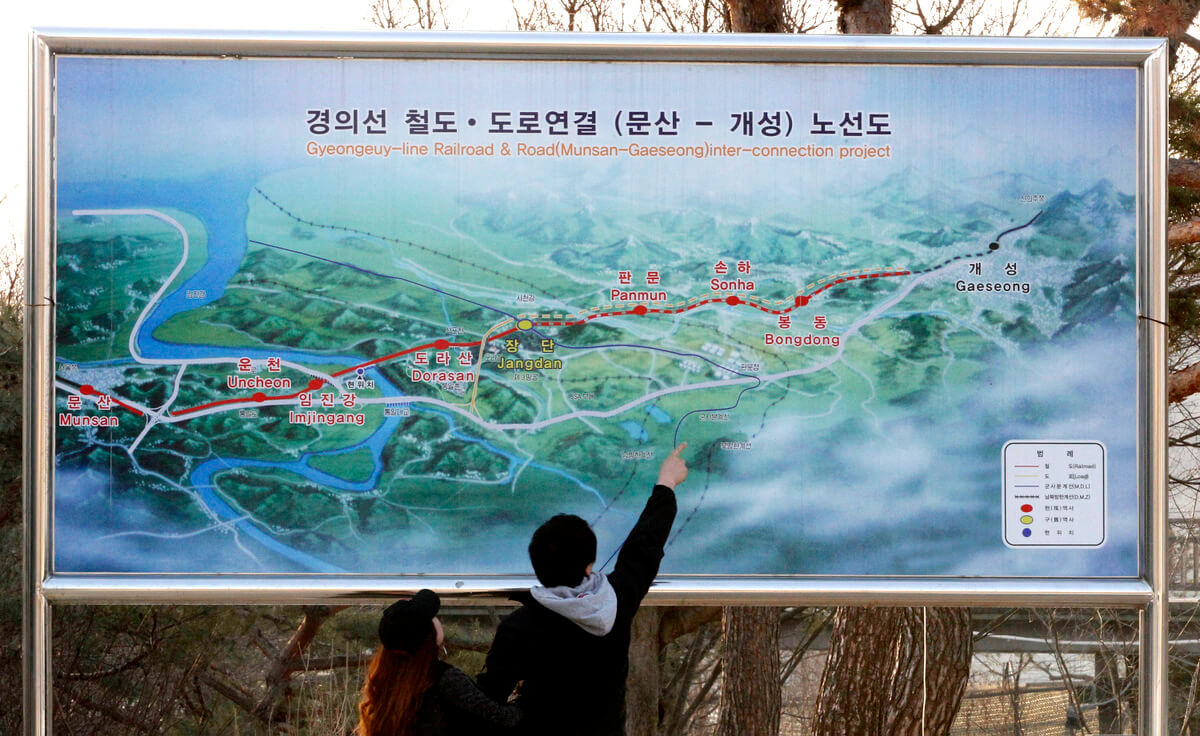 A couple looks at a map of railroad linking two Koreas, the two Koreas hope to reconnect as part of an agreement reached at a historic summit of Kim Dae-jung from South and Kim Jong Il from North in 2000, March 31, 2013. Ahn Young-joon | AP