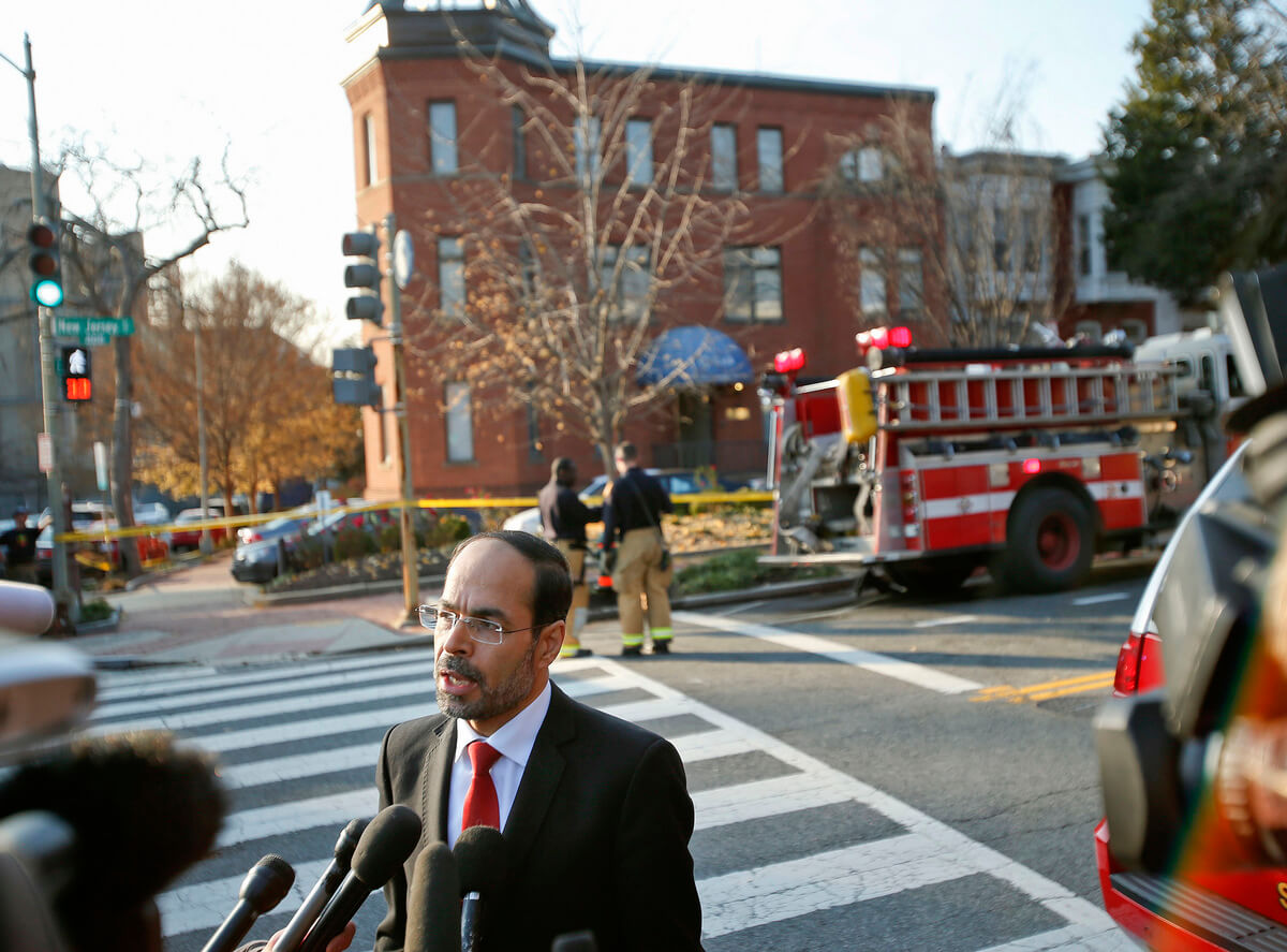 Council on American-Islamic Relations (CAIR) Executive Director and co-founder Nihad Awad speaks to members of the media as firefighters are seen in the background at CAIR headquarters on Capitol Hill in Washington after the building was evacuated. A spokesman for a the group said its headquarters on Capitol Hill have been evacuated after staffers came in contact with a suspicious substance that arrived in the mail, Dec. 10, 2015. Pablo Martinez Monsivais | AP