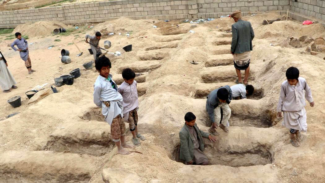 Young boys inspect graves prepared for victims of Saudi Arabia's airstrike on a school bus in Saada province, Yemen, August 10, 2018. Naif Rahma | Reuters
