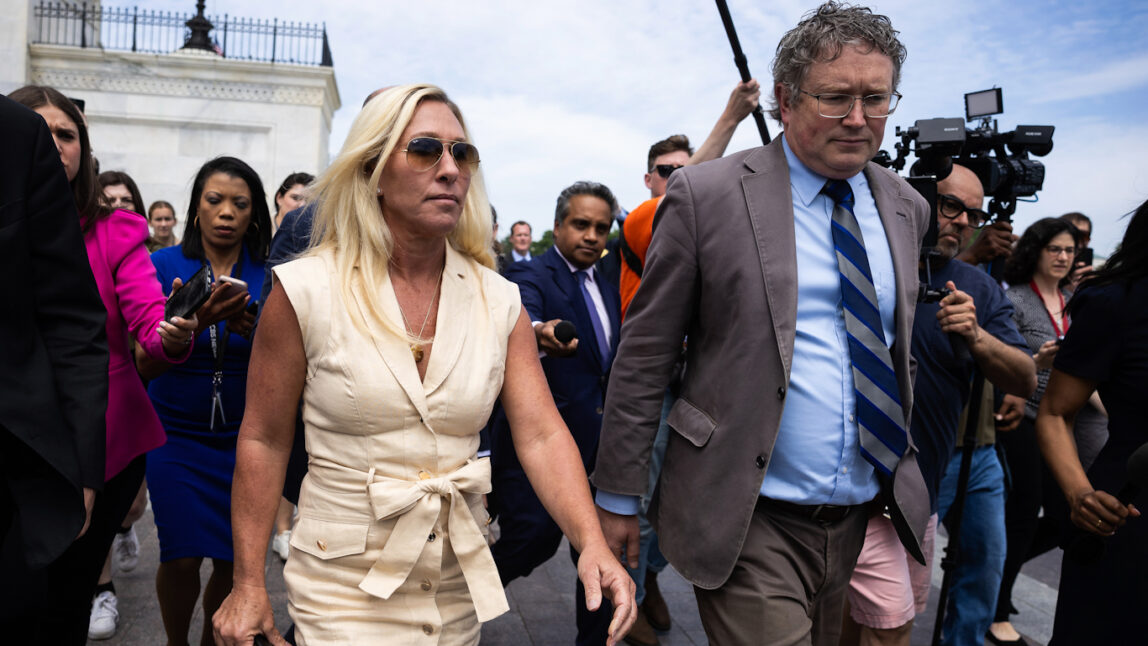 Greene and Massie walk through Capitol surrounded by reporters, April 30, 2024