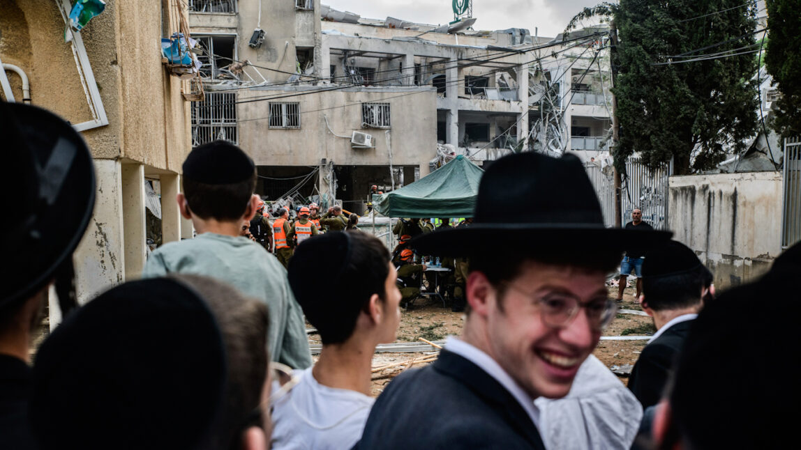 Israelis gather next to a direct hit site following an Iranian missile strike against Israel, June 16th 2025. Matan Golan | AP