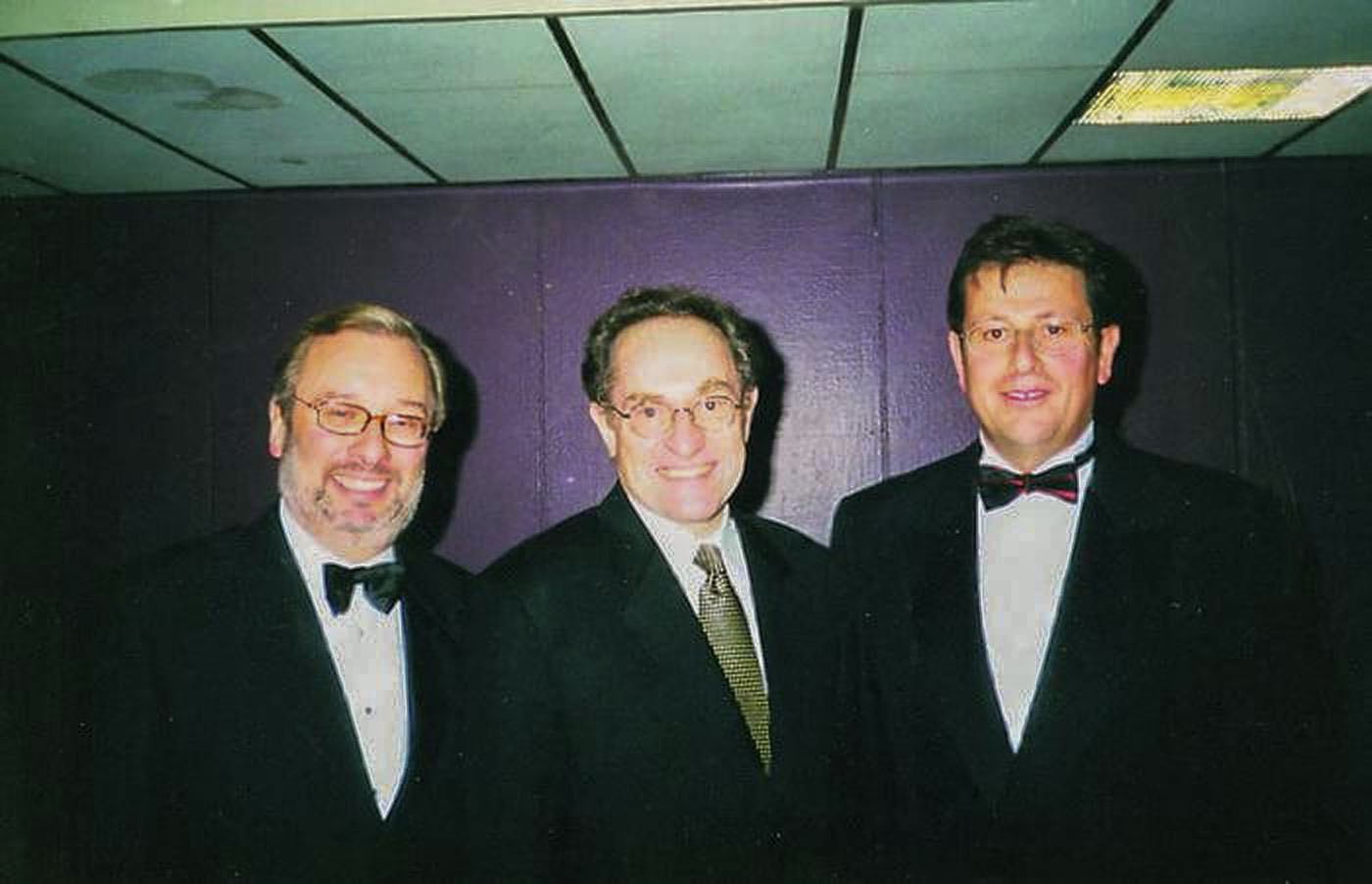 Alan Dershowitz (center), Samuel Kingsley (right), and Geoffrey Ognall (left) at a UJIA dinner in Glasgow, November 1998. Photo | Source